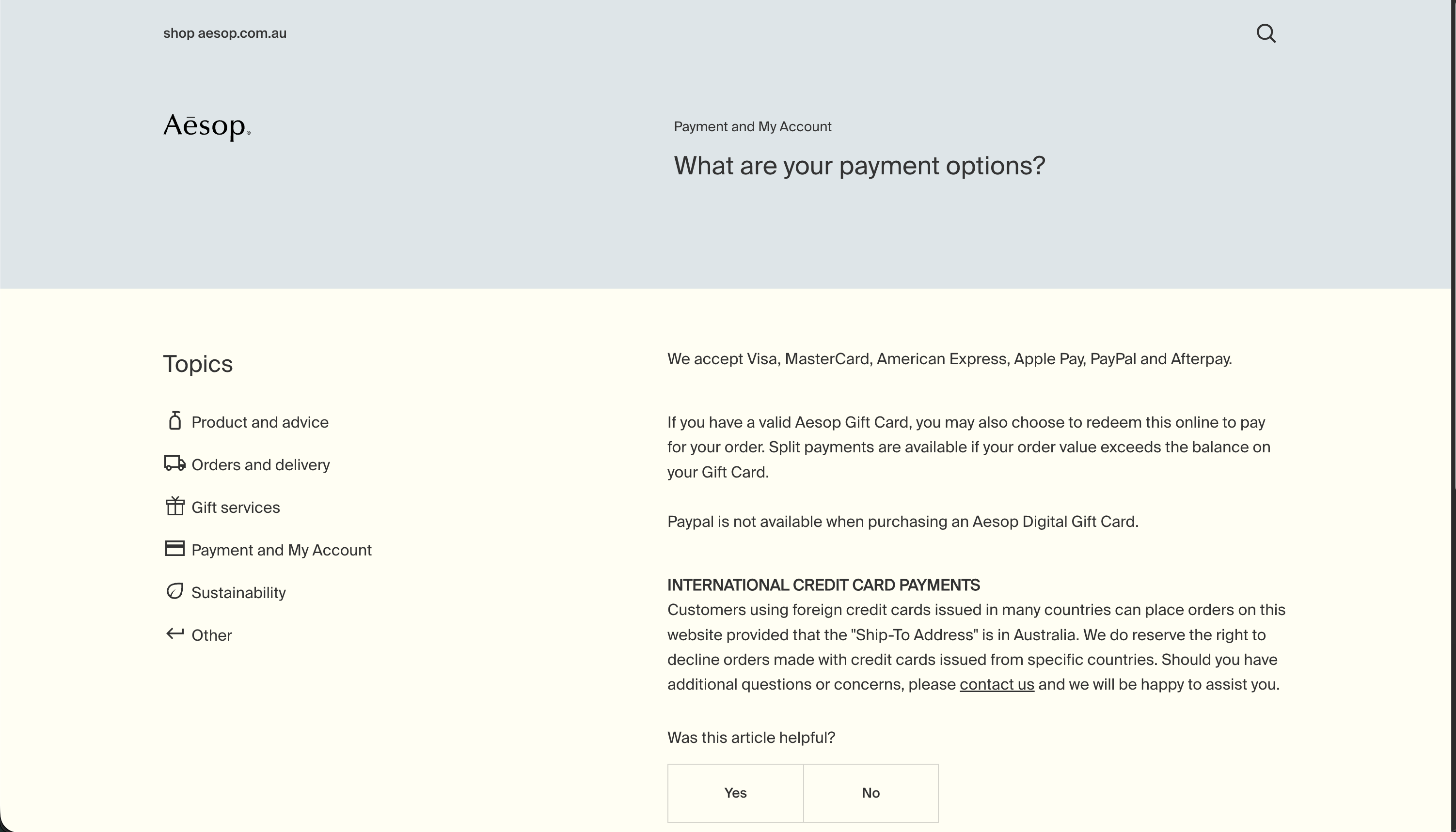 Aesop help article page under 'Payment and My Account' explaining international credit card payments, with sidebar topic navigation and article feedback buttons